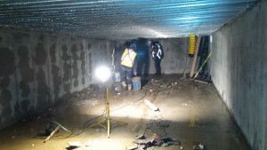 Workers finish cleaning out a water retention tank beneath a parkade project in downtown Kamloops.